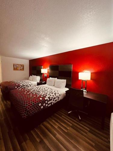 a hotel room with a bed and a red wall at econo lodge in San Antonio