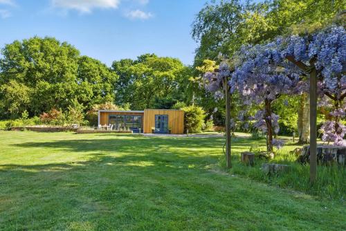a house in the middle of a park with trees at Independent rural detached annexe with free private Parking in Canterbury