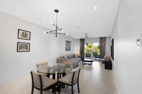 a dining room and living room with a table and chairs at Modern Condo at One Cable Beach with Balcony in Nassau