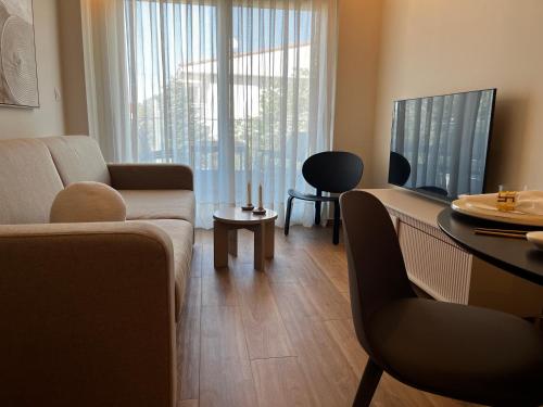 a living room with a couch and a table at Siesta Thassos - Luxury Apartment in Skala Rachoniou