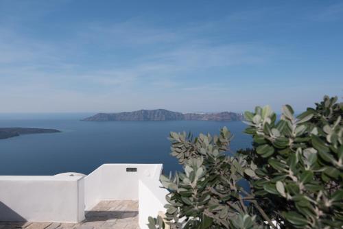 a view of the blue ocean from a house at Smaro Studios in Firostefani