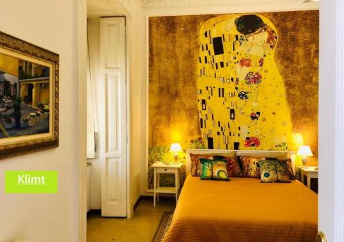 a bedroom with a bed with a painting on the wall at RarityArt GuestHouse in Salerno
