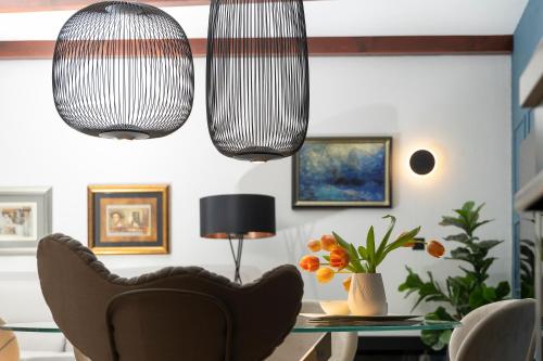 a living room with two hanging lights and a table at Villa Nauta in Lovište