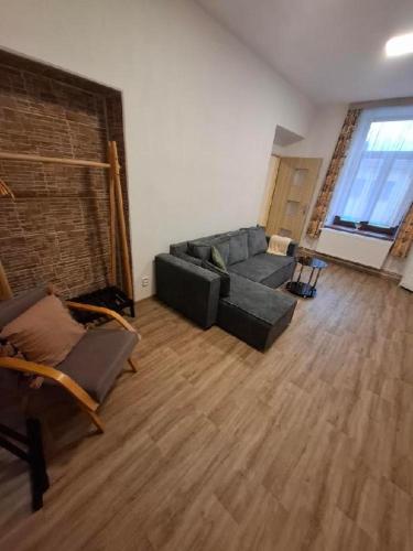 a living room with a couch and a brick wall at Hotel U Beránků in Libochovice
