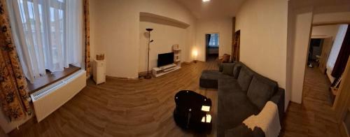 a living room with a couch and a television at Hotel U Beránků in Libochovice