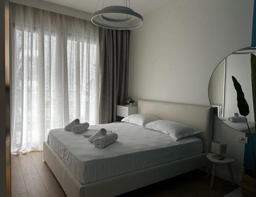 a bedroom with a bed with two towels on it at LARIMAR Lungomare Vlore in Vlorë