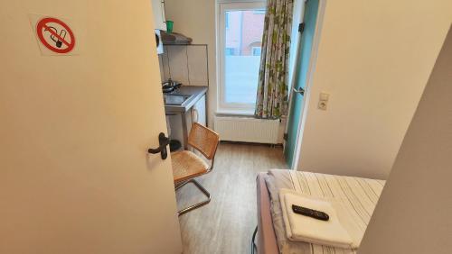 a room with a bed and a table and a chair at Aparthotel B & L in Bremen