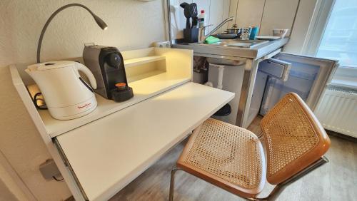 a kitchen with a counter with a coffee maker on it at Aparthotel B & L in Bremen