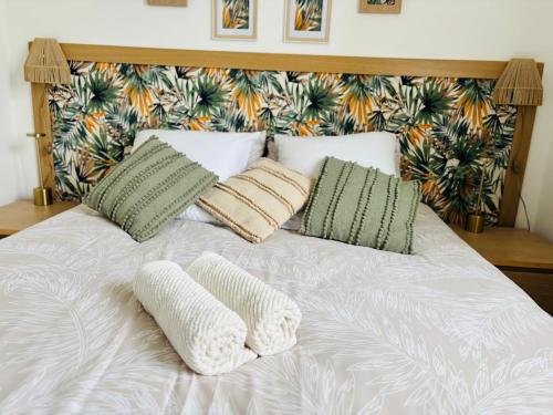 a white bed with two pillows on top of it at La Belle Escale d'Epinay aux portes de Paris in Épinay-sur-Seine