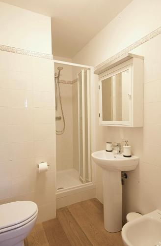 a bathroom with a toilet and a sink and a shower at Le Camere Pietrasantine - Garage Bonci in Pietrasanta