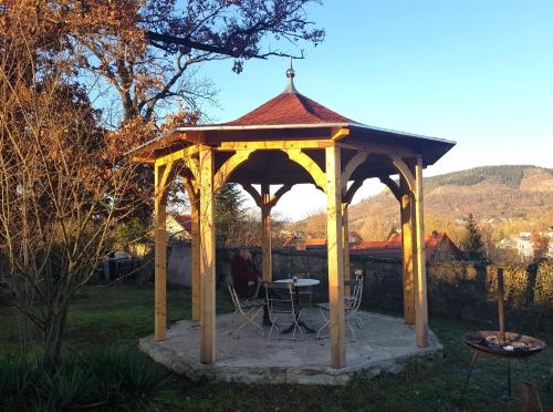 a wooden gazebo with a table and chairs in a yard at Binderburg, Jena in Jena