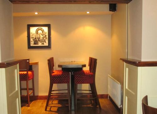 a dining room with a table and four chairs at Bank House Guesthouse in Bundoran