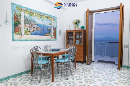 a dining room with a table and chairs at MAR-ISA Amalfi Coast in Vietri sul Mare