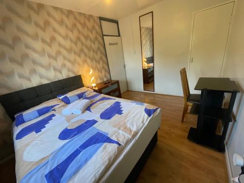 a bedroom with a large bed with blue and white sheets at Birmingham city centre lovely family gateway in Birmingham