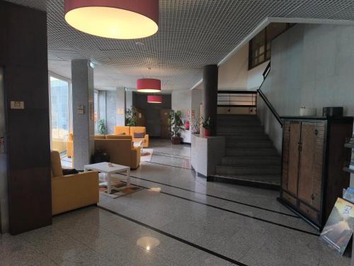 a lobby with a staircase in a building at Douro Marina Hotel & SPA in Resende