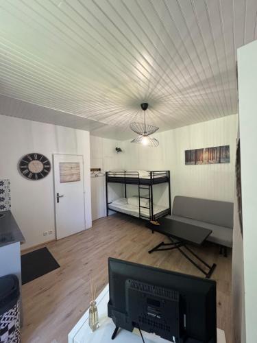 a living room with a bunk bed and a television at Studio Cauterets 30m2 in Cauterets