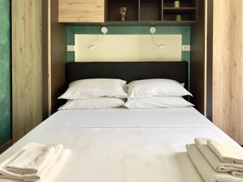 a bedroom with a bed with white sheets and pillows at Poet's rooms in Taormina
