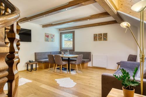 a living room with a table and chairs at Hotel Alte Post in Grossarl