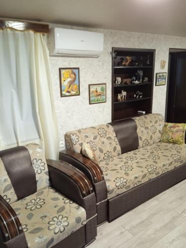 a living room with a couch and a chair at Guesthouse - Happy house in Kutaisi in Kutaisi