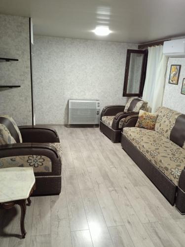 a living room with two couches and a couch at Guesthouse - Happy house in Kutaisi in Kutaisi