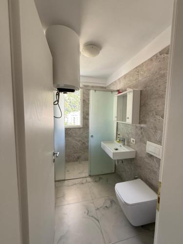 a bathroom with a toilet and a sink at 9apartaments Shengjin in Shëngjin
