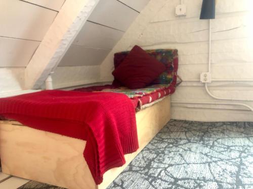 a bed with a red blanket sitting in a room at New Everything! Gorgeous Log Cabin in Downtown Joseph in Joseph