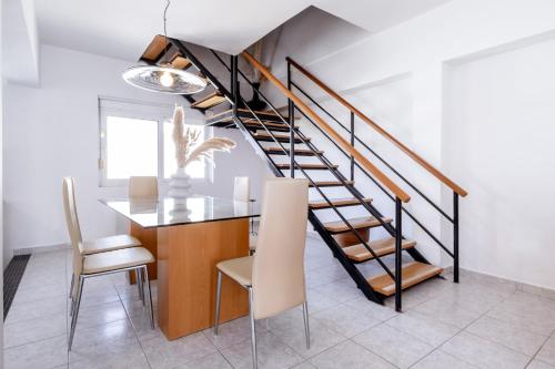 a dining room with a staircase and a table and chairs at Marys House 2 in Rhodes Town