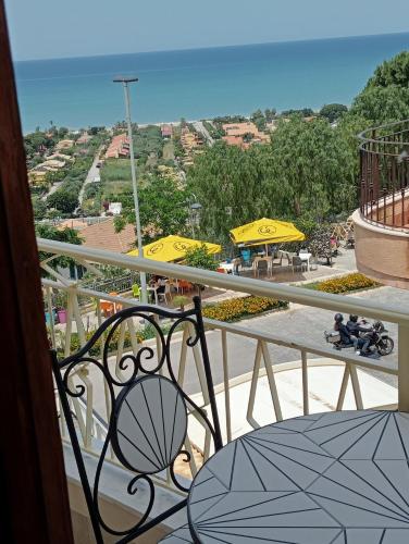 a balcony with a view of a city with umbrellas at Casa Karmel in Campofelice di Roccella