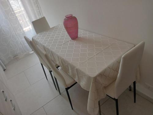 a table with a vase sitting on top of it at Casa Karmel in Campofelice di Roccella