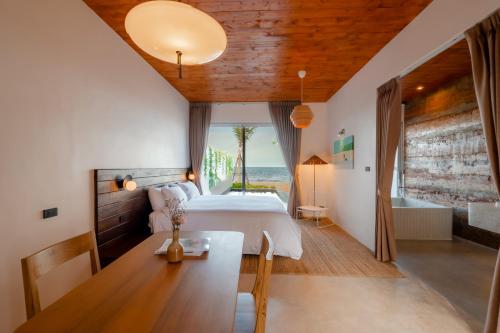 Postel nebo postele na pokoji v ubytování Furusato Shack Pranburi ฟูรุซาโตะ แชค ปราณบุรี ふるさとシャック