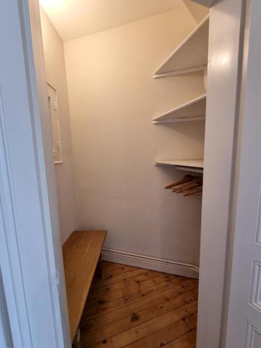 a walk in closet with wooden floors and shelves at La Villa des Tendances in Soissons