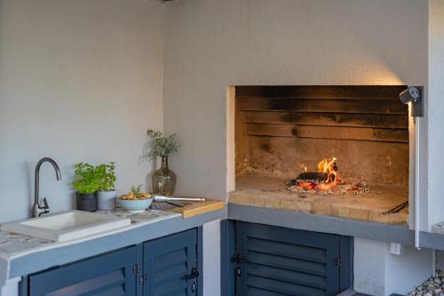 a kitchen with a stove with a fire in it at Bella Zara lux apartment with jacuzzi, grill & garden in Zadar