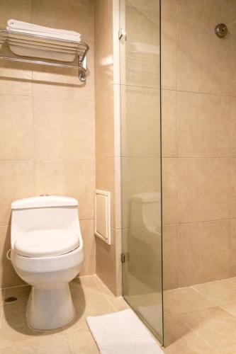 a bathroom with a toilet and a glass shower at Zuana Beach Resort in Santa Marta