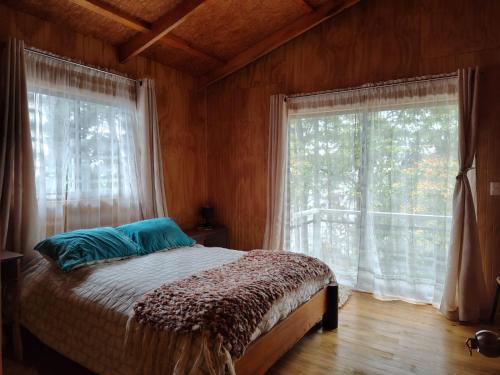 a bedroom with a bed and a large window at La Casona De Junia in Puerto Rico