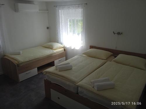 two twin beds in a bedroom with a window at Apartment One2one in Bovec