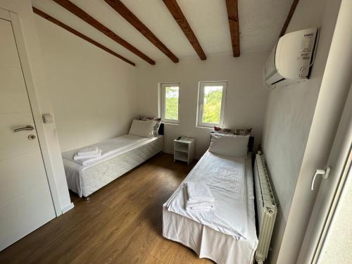 a room with two beds and a window at Villa IMAN in Sarajevo