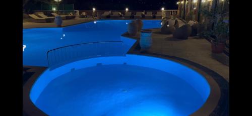 a large swimming pool lit up at night at Nikos Apartments Corfu in Agios Stefanos