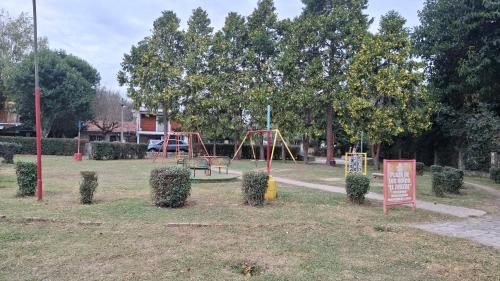 a park with a swing set and a playground at Bajo el Roble in El Volcán