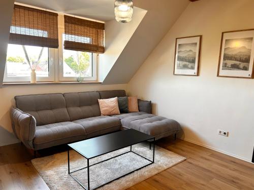 a living room with a couch and a table at Maisonette-Apartment mit Klimaanlage - in Dorsten Zentrum - in Dorsten
