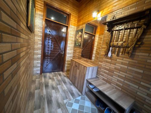 a wooden room with a bench and a door at Bag Evi - Villa in Quba