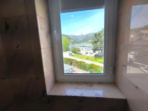 a window in a room with a view at Douro Marina Hotel & SPA in Resende