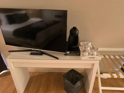 a tv sitting on a white table with a television on it at Douro Marina Hotel & SPA in Resende