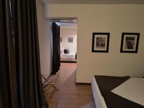 a bedroom with a bed and a room with a bed sqor at Douro Marina Hotel & SPA in Resende