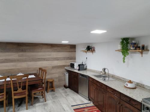 a kitchen with a table and a dining room at Belo Encanto do Paiva in Castelo de Paiva