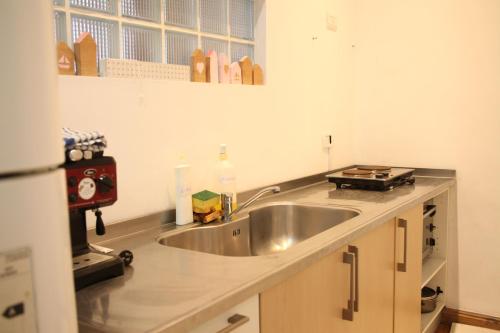 a kitchen with a sink and a counter top at La Casona in La Plata