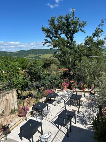 a group of tables and chairs on a patio at Saturnia Residence in Poggio Murella