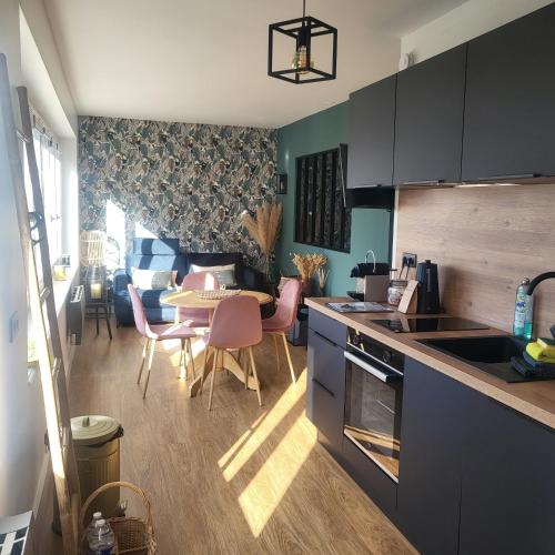 une cuisine avec une table et une salle à manger dans l'établissement Le Paille en Queue, à Fouesnant