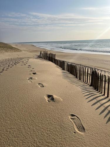 une paire d'empreintes de pieds dans le sable sur une plage dans l'établissement Maisonette Landaise, à Vielle-Saint-Girons