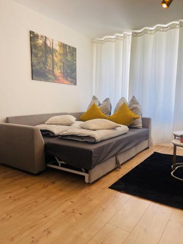 a couch sitting in a living room with at Schwarzwald-Idylle in Schonach in Schonach
