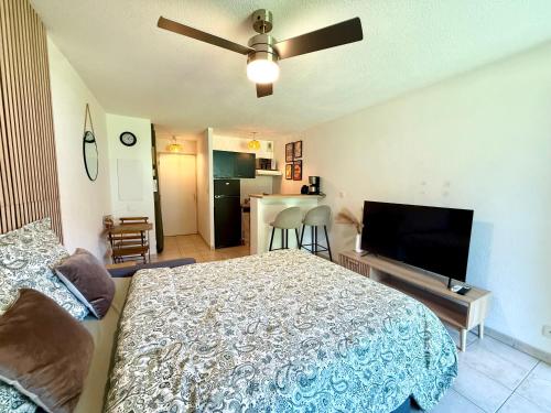 une chambre avec un lit et une télévision à écran plat dans l'établissement Lum'Arles, à Arles